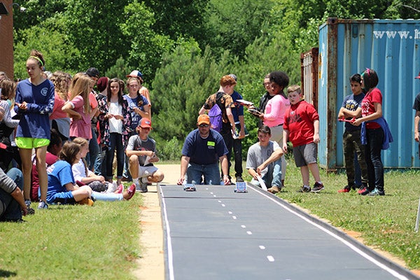 Students racing solar cars on a track