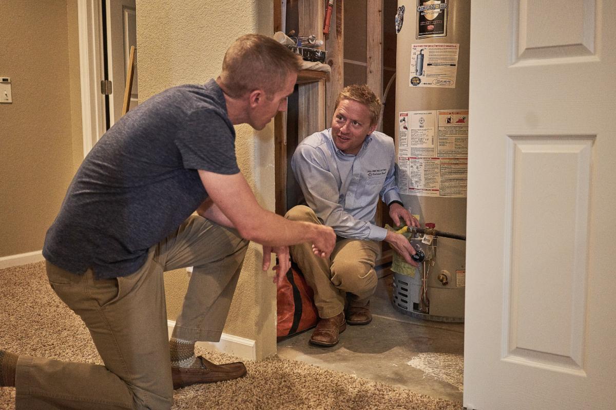 two men checking a water heater
